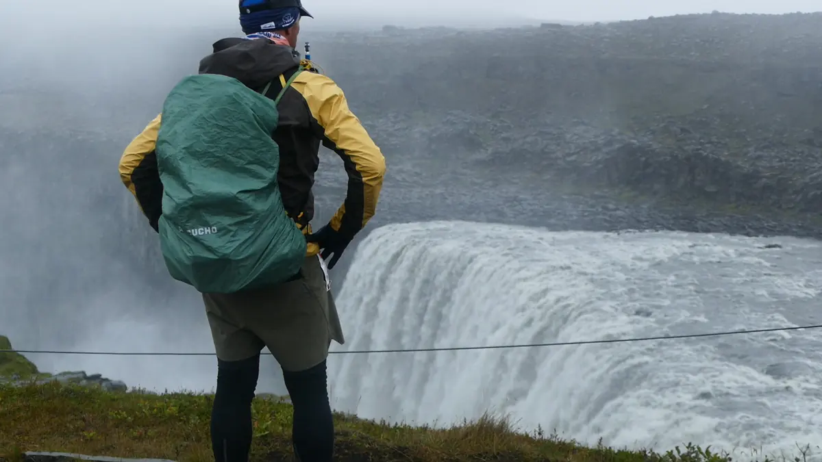 A runner stands beside the waterfall during the 2026 race